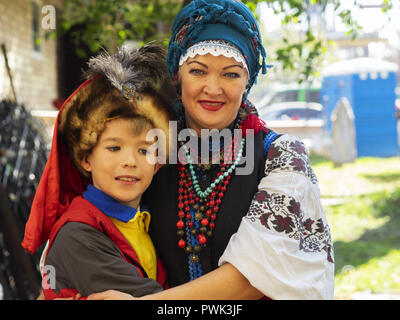 October 14, 2018 - Borisptyl, Kiev, Ukraine - A woman in national costume seen with her son during the celebrations..The Protection of the Virgin is a national holiday celebrated by the Ukrainian Orthodox Church. On this day, at the same time, the holiday of the Ukrainian Cossacks, the Day of the creation of the Ukrainian Rebel Army and the Day of Defender of Ukraine are celebrated. (Credit Image: © Igor Golovniov/SOPA Images via ZUMA Wire) Stock Photo