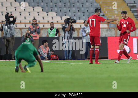 Tehran, Iran. 16th Oct, 2018. Iran's Mehdi Torabi (R) celebrates scoring his side's second goal with teammate Mehdi Taremi during an International Friendly soccer match between Iran and Bolivia at the Azadi Stadium. The Iranian authorities have allowed women to attend the match after a request from the Football Federation of the Islamic Republic of Iran. Credit: Saeid Zareian/dpa/Alamy Live News Stock Photo