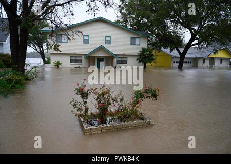 Heavy rains in the Texas Hill Country cause flooding on Lake LBJ, with mud- and debris-filled water inundating lakefront homes Stock Photo