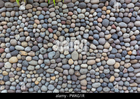 Background texture, wall consisting of small river stones. Stock Photo
