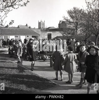 1950s, historical, education, fresh air at break-time, children in coats and hats outside in the playground at a English village primary school, Engalnd, UK. Stock Photo