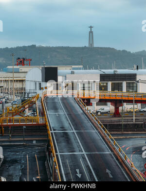 Busy overpass cityscape view with Cristo Rei statue in background, Lisbon, Portugal. Stock Photo