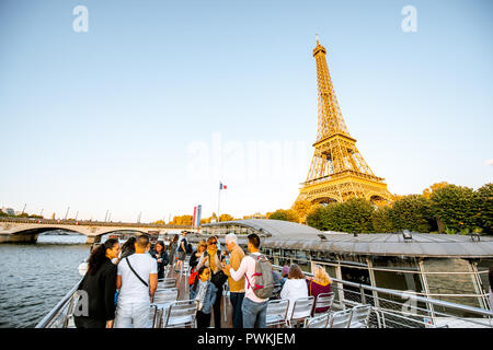 PARIS, FRANCE - August 31, 2018: Tourists enjoy water tour on Seine river sailing on the two stored open boat in Paris Stock Photo