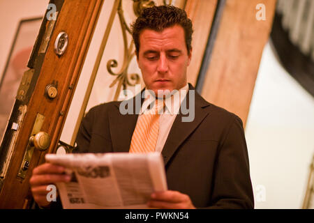 A man reading a newspaper Stock Photo
