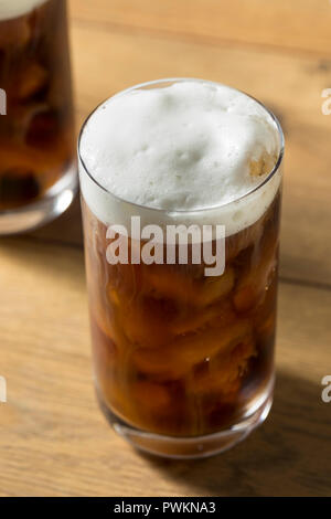 Tasty fresh cold iced coffee with milk in glasses on table. Square ...