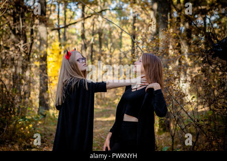 Halloween demon and witch in the woods. Stock Photo