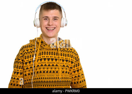 Young happy Caucasian man smiling while listening to music with headphones Stock Photo