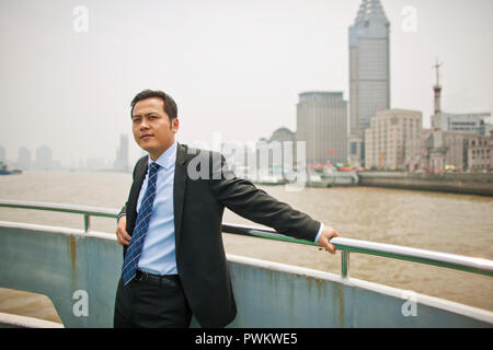 Businessman leaning against railing. Stock Photo