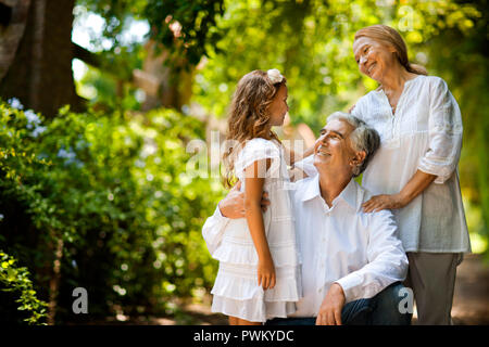 Portrait of young girl with her grandparents. Stock Photo