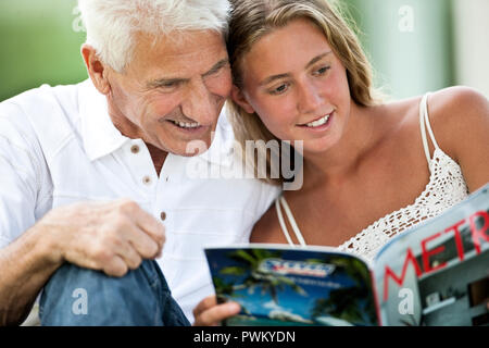 Portrait of senior man with his teenage granddaughter. Stock Photo