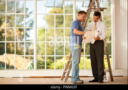 Two businessmen looking at samples on a construction site. Stock Photo