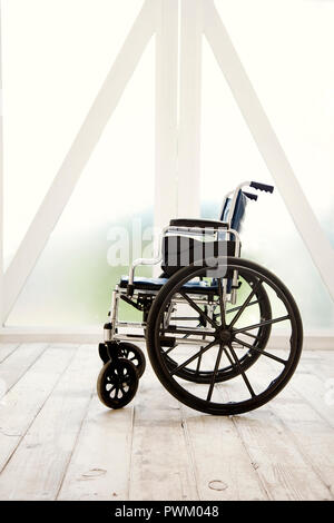 An empty wheelchair inside a room. Stock Photo