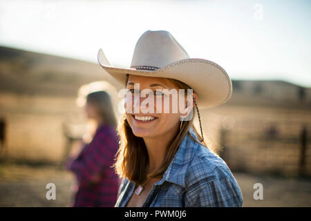Portrait of a smiling rancher wearing a cowboy hat while out on the ranch. Stock Photo