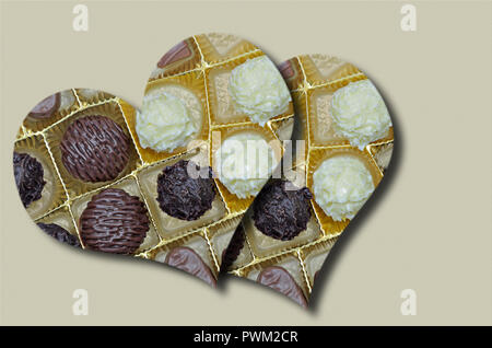 two hearts with chocolates and biscuits on beige background, close up, full frame, horizontal. slanted Stock Photo
