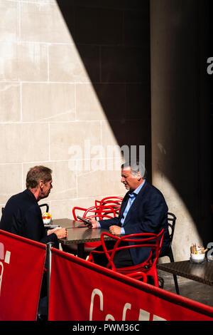 England,London,The Financial district. Meeting clents out of the office-corporate employees having a concersation on their lunch break Stock Photo