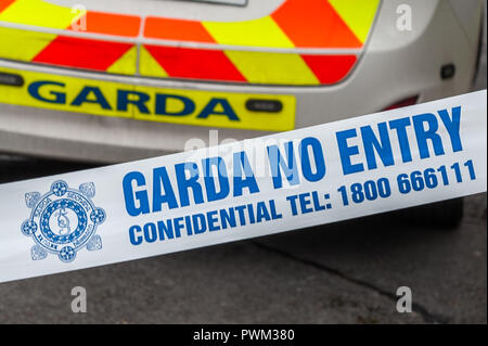 Garda (Irish Police) No Entry tape in front of a Garda Patrol car at an incident in Ireland. Stock Photo