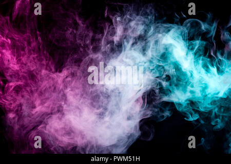 Textural background for creativity . Dense multicolored smoke of   blue and pink colors on a black isolated background. Background of smoke vape Stock Photo