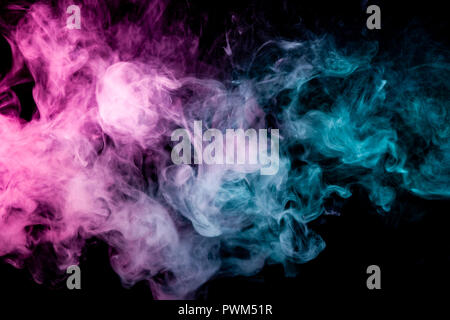 Textural background for creativity . Dense multicolored smoke of   blue and pink colors on a black isolated background. Background of smoke vape Stock Photo