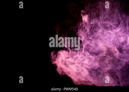 Textural background for creativity . Dense multicolored smoke of   red and pink colors on a black isolated background. Background of smoke vape Stock Photo