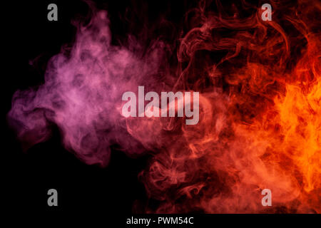 Textural background for creativity. Thick colorful smoke of pink, red on a black isolated background. Background from the smoke of vape Stock Photo
