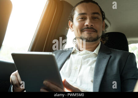 middle eastern businessman inside a car passenger Stock Photo