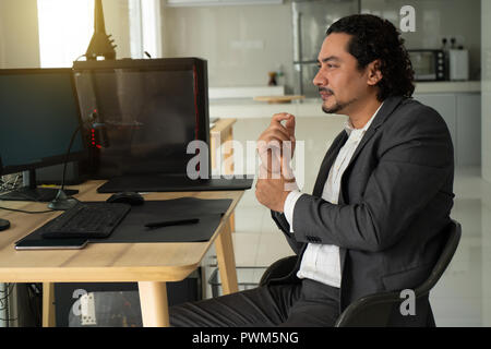 Handsome arab man suffering from wrist pain in office, closeup Stock Photo