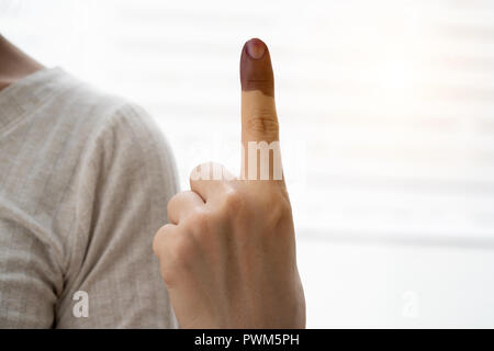 A finger mark with indelible ink at a polling station in Malaysia Stock Photo