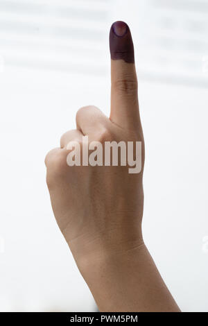 A finger mark with indelible ink at a polling station in Malaysia Stock Photo