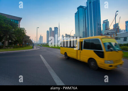 Dubai city downtown and bus moving on the road Stock Photo