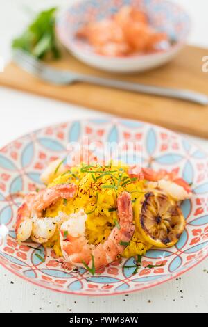 Saffron risotto with prawns Stock Photo