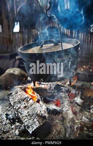 A Dutch oven over a camp fire Stock Photo