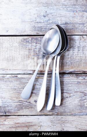Several soup spoons on a wooden background Stock Photo