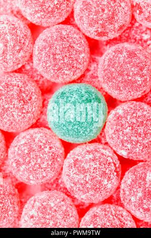 Pink jelly tots with a green jelly tot Stock Photo
