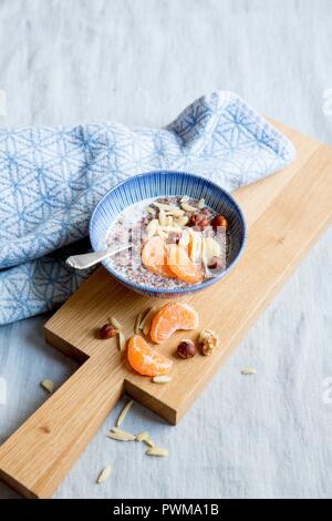 Flaxseed pudding with nuts and tangerines Stock Photo