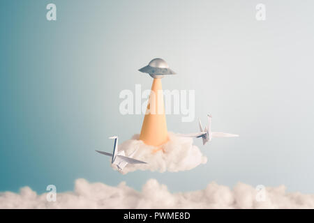 A UFO scanning a cloud to find something Stock Photo