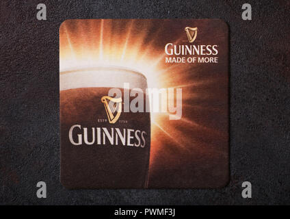 LONDON, UK - AUGUST 22, 2018: Guinness paper beer beermat coaster isolated on black background. Stock Photo