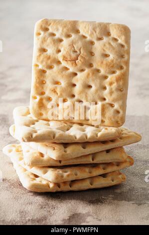 A stack of crackers with one standing on edge Stock Photo