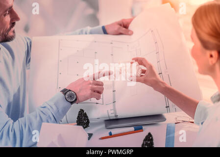 Focused photo on male hand that pointing at building Stock Photo