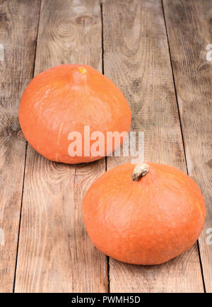 Two autumn pumpkins on wooden background close up Stock Photo