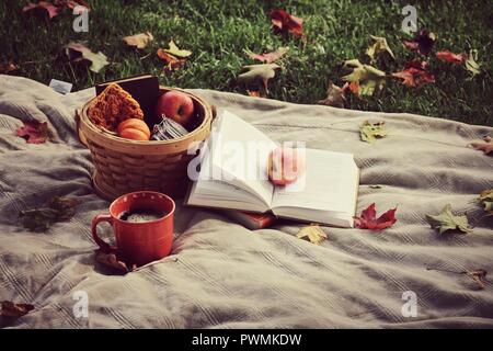 Autumn. Blanket, Orange Mug, Hot Coffee, Apples, Books, Leaves, Pumpkin. Crisp Autumn Weather. autumn Photography Stock Photo
