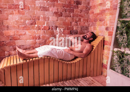 Nice brunette young man feeling absolutely relaxed Stock Photo