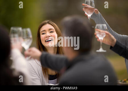 Group of friends reading a digital tablet in the park. Stock Photo