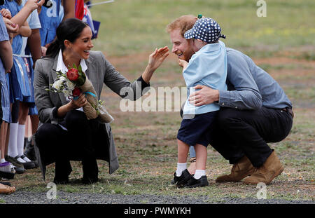 The Duke and Duchess of Sussex talk to Luke Vincent, 5, after arriving at Dubbo airport, in Australia, on the second day of their tour to the country. Stock Photo