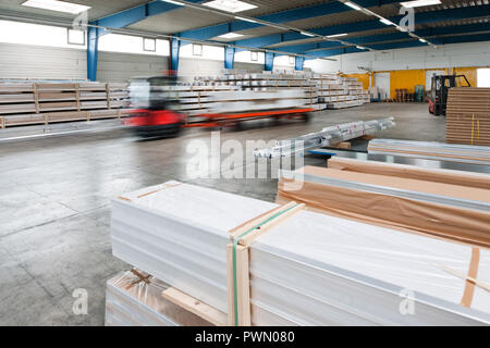 Fork lifter at work driving through warehouse Stock Photo