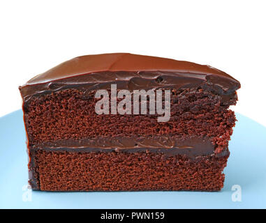 Piece of Delectable Chocolate Layer Short Cake Served on Blue Plate Isolated on white background with Free Space for Design and Text Stock Photo