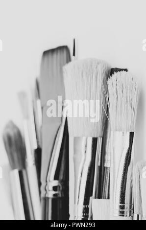 set of painting brushes on empty surface backdrop - visual arts concept
