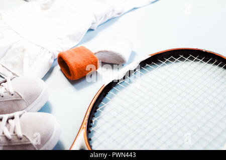 Sport and fitness healthy lifestyle composition with tennis racket and athletic wear. Stock Photo