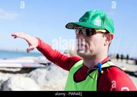 Man winning paddle board race and explaining the trip Stock Photo