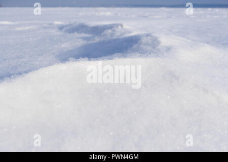Close-up snowdrift white loose fresh snow. Perspective view.  Stock Photo