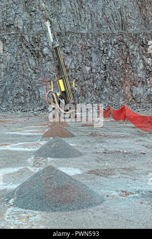 Driller in a Porphyry mine quarry. industrial tools. Stock Photo